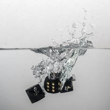 Dice drop in water Stock Photos