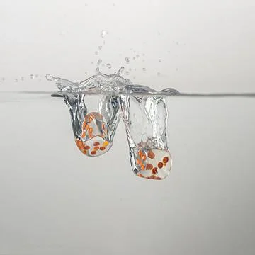 Dice drop in water Stock Photos