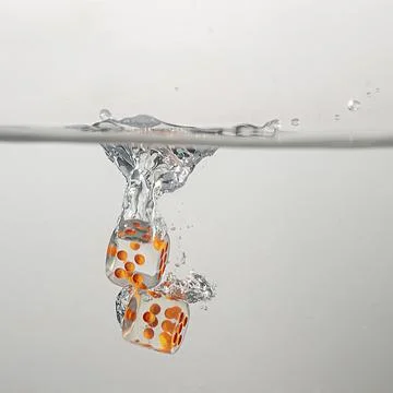 Dice drop in water Stock Photos