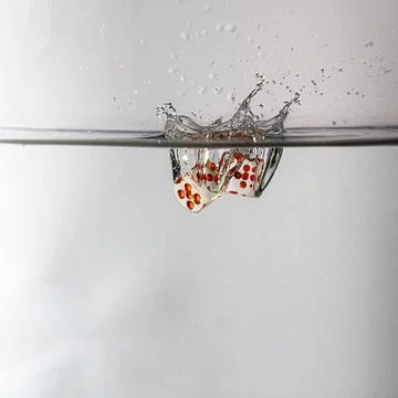 Dice drop in water Stock Photos