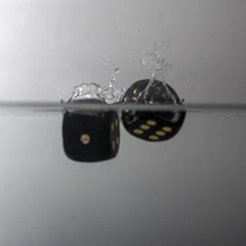 Dice drop in water Stock Photos