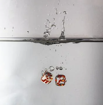Dice drop in water Stock Photos