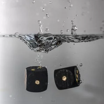 Dice drop in water Stock Photos