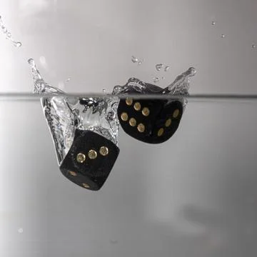 Dice drop in water Stock Photos