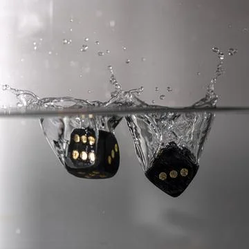 Dice drop in water Stock Photos