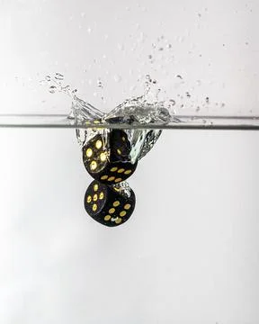 Dice drop in water Stock Photos
