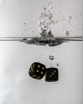 Dice drop in water Stock Photos