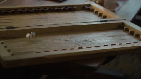 Dice fall onto a wooden backgammon board and roll. the game starts. slow motion Stock Footage 160985336
