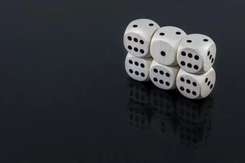 Dice five horizontal sixes and one in the center on a black background Stock Photos