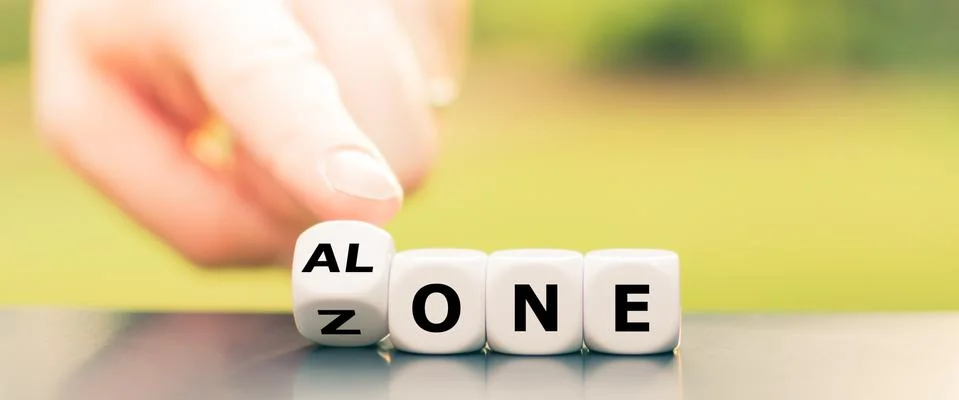 Dice form the expression "alone zone". Stock Photos