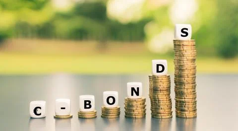 Dice form the expression "-Bonds" on increasing high stacks of coins. Stock Photos