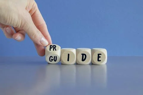 Dice form the expression 'pride guide'. Beautiful blue background Stock Photos