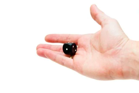 Dice in hand. Playing cube black in a hand Stock Photos