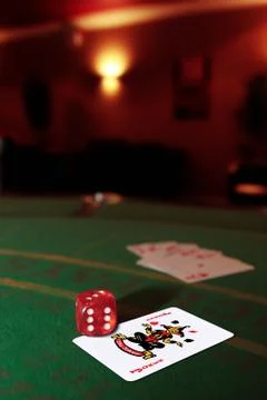 Dice on the joker in the pack Stock Photos