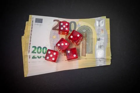Dice lay on a stack two hundred euro banknotes Stock Photos