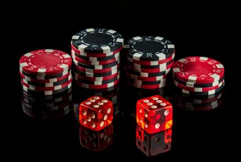 Dice with a maximum winning combination of twelve in poker on a black table Stock Photos