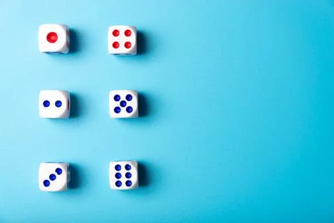Dice with numbers on a blue background. Dice minimalism Stock Photos
