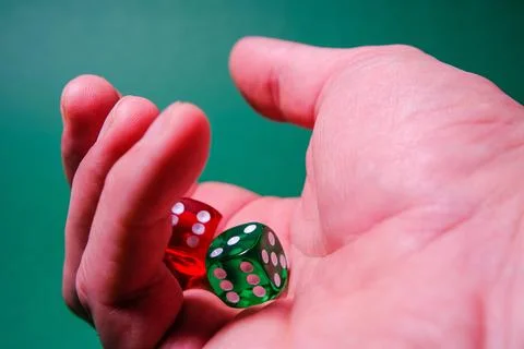 Dice in the player's hand Stock Photos