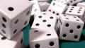 Dice rolling white slow motion closeup DOF on blue felt tabletop HD Footage