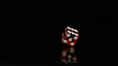 Dice spinning on black surface, Slow Motion Stock Footage 25399817