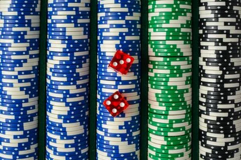 Dice on a stack of poker chips Stock Photos