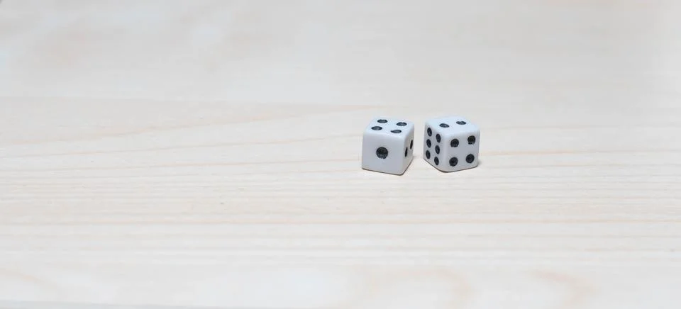 Dice on a table side by side Stock Photos