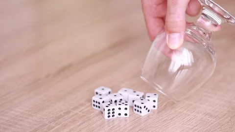 Dice thrown down from glass 動画素材 98480469