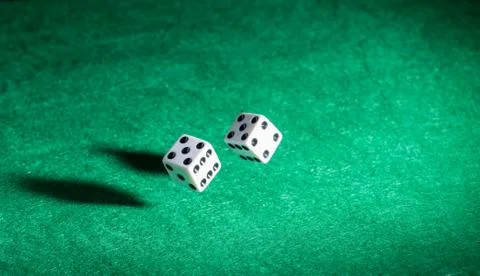 Dice thrown on a green table Stock Photos