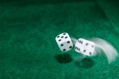 Dice thrown on a green table Stock Photos