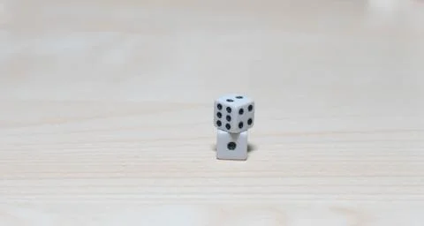 Dice on top of a table stack on top of each other Stock Photos