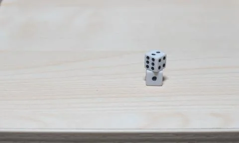 Dice on top of a table stack on top of each other Stock Photos
