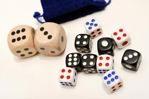 Dice on a white background. Large and small dice. Stock Photos