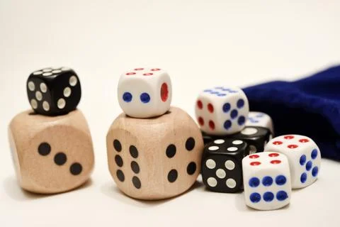 Dice on a white background. Large and small dice. Stock Photos
