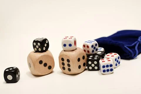 Dice on a white background. Large and small dice. Stock Photos
