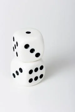 The dice on a white table Stock Photos