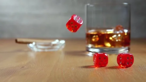 Dice on a Wooden Table and Glass of Whiskey. Slow Motion Stock Footage 130124526