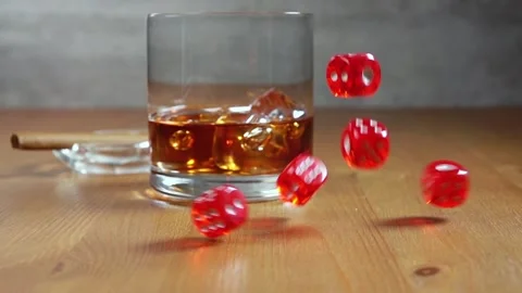 Dice on a Wooden Table and Whiskey in Highball. Slow Motion Stock Footage 129040714
