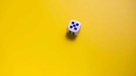 Dice on a yellow surface 스톡 사진