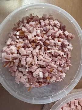 Diced bacon pieces in a plastic container ready for cooking 스톡 사진