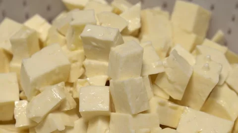 Diced cheese chunks for cooking, baking, and food preparation Stock Footage 331565519