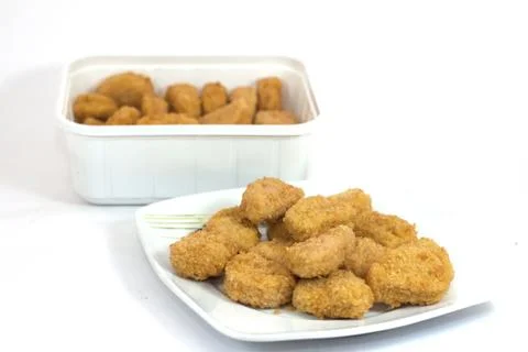 Diced chicken nuggets breaded ready for eating Stock Photos