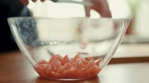 Diced Fresh Tomatoes inside Transparent Glass Bowl on Kitchen Counter Stock Footage 347130526