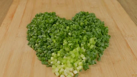 Diced green onions stacked to form a heart shape. Stock Footage 340321897