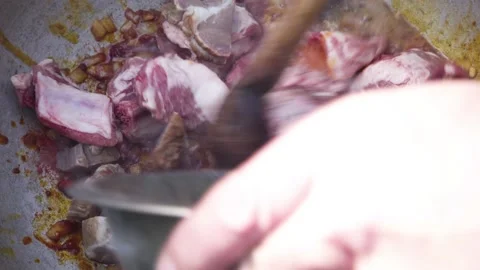Diced lard is fried in a pan mixed with a wooden spoon. 스톡 동영상 149919007