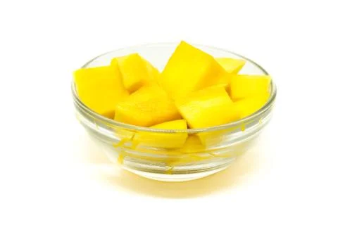 Diced mango cubes placed and served on a glass bowl isolated on a white Stock Photos