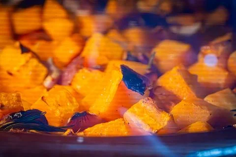 Diced orange squash cooking in a pan Stock Photos