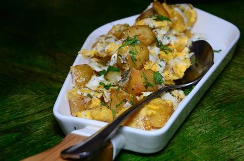 Diced potato fried with eggs. Stock Photos