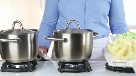 Diced potatoes and savoy cabbage being added to a pot of boiling water 스톡 동영상 24658306