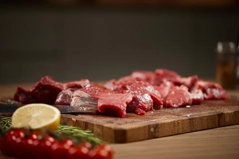 Diced raw beef pieces on cutting board Stock Photos