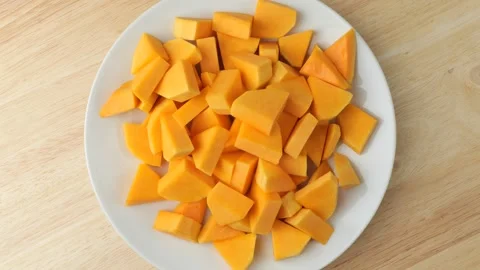 Diced raw butternut squash rotating on a plate 스톡 동영상 346739579